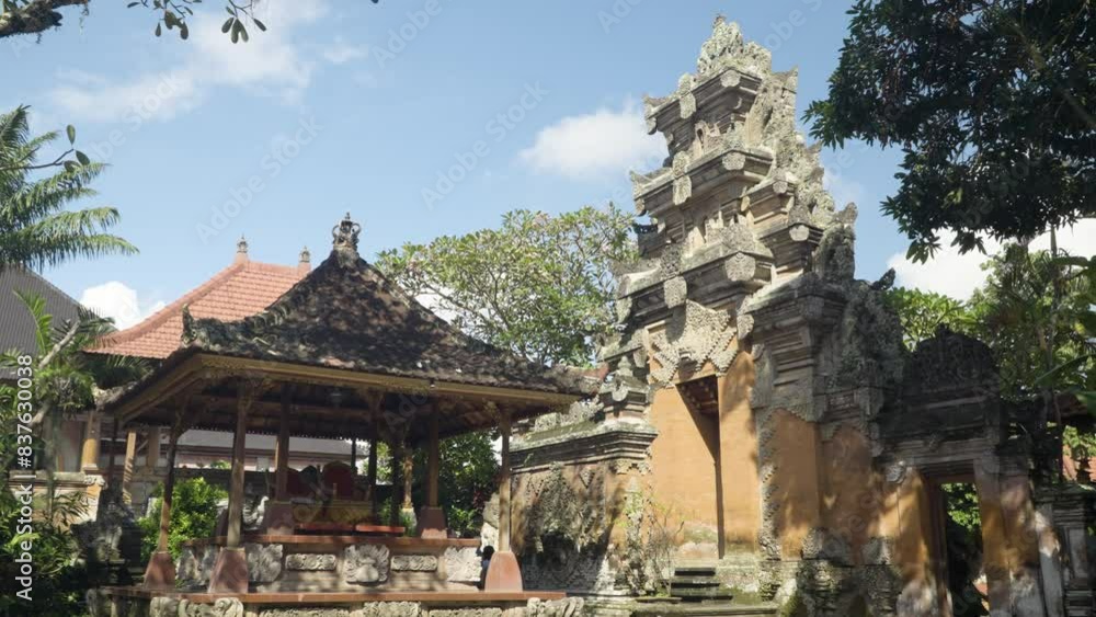 Ornamented Angkul Doors and Pavilion with Royal Chair Inside Ubud Palace, Puri Saren Agung - historical Balinese Architecture in Ubud, Gianyar Regency of Bali, Indonesia - tilt down pan reveal Ornamented Angkul Doors and Pavilion with Royal Chair Inside Ubud Palace, Puri Saren Agung - historical Balinese Architecture in Ubud, Gianyar Regency of Bali, Indonesia - tilt down pan reveal