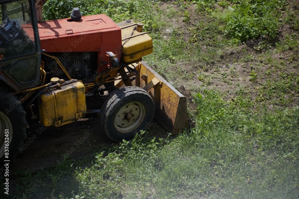 Drilling bulldozer clears construction site of green grass Drilling bulldozer clears construction site of green grass