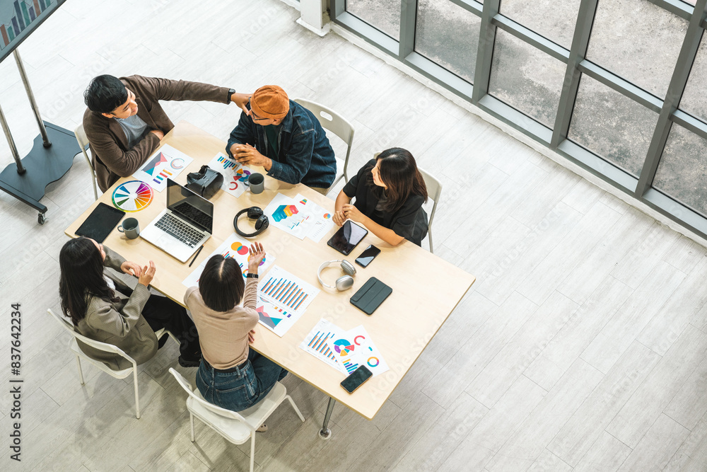 © Chanakon - Asian business start up freelance people team analyzing statistics financial. Group Team of businesspeople man and woman Meeting Conference Discussion various topic Corporate Concept in office.