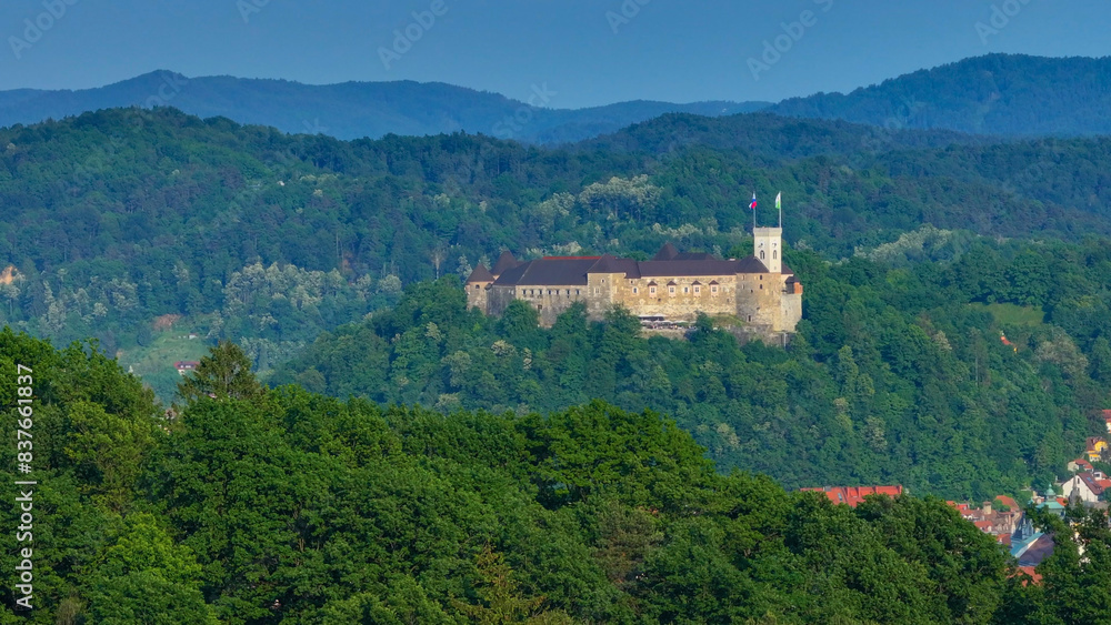AERIAL: Panoramic view of a historic Ljubljana surrounded by the lush forests. AERIAL: Panoramic view of a historic Ljubljana surrounded by the lush forests.