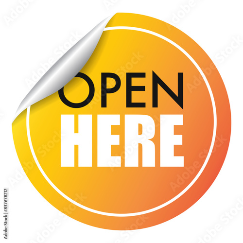 OPEN HERE sticker circle shape yellow color, guiding user on where to access or begin