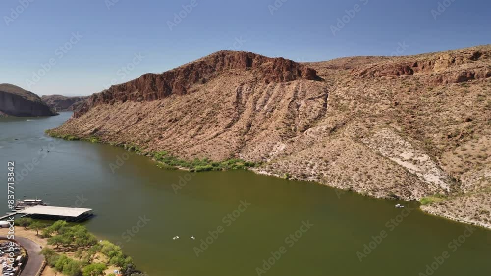 Canyon Lake in Tortilla Flat Az near Phoenix panning right aerial drone view of the mountains, water, cars, and boats. Canyon Lake in Tortilla Flat Az near Phoenix panning right aerial drone view of the mountains, water, cars, and boats.