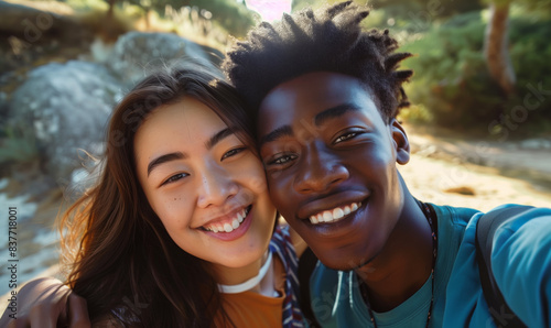 Selfie of a cute young couple in nature. African American man and Japanese woman. Romantic selfie.