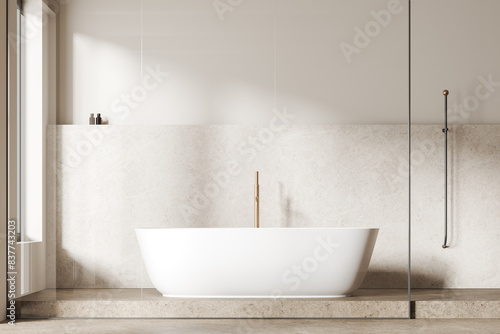 Modern bathroom with a freestanding white bathtub  light beige tiled wall  and minimalistic decor  light background  concept of contemporary and minimalist design.  3D Rendering