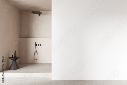 Beige hotel bathroom interior with douche, accessories and mockup wall photo