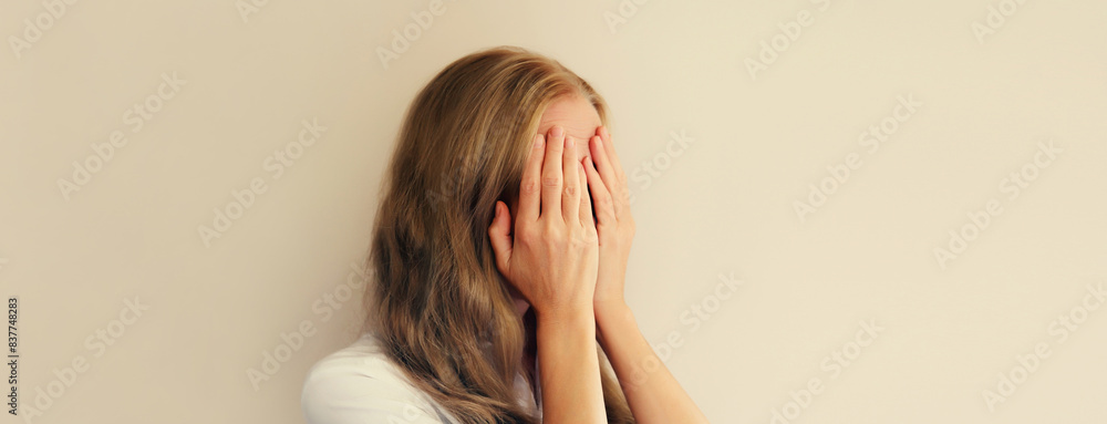 Fototapeta premium Upset sad crying woman experiencing mental or physical suffering
