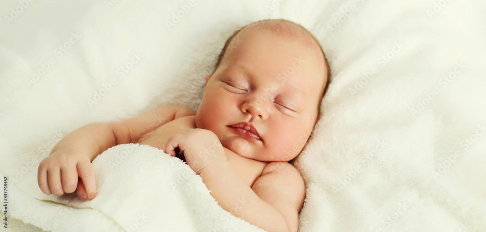 Portrait of infant sweet sleeping lying on white bed at home Portrait of infant sweet sleeping lying on white bed at home