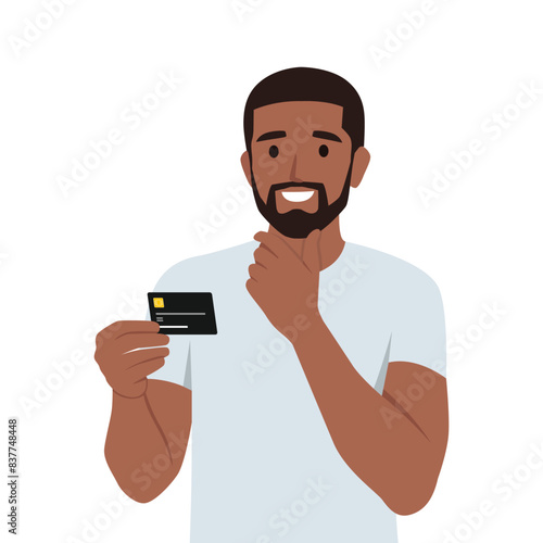 Young man thinking about using black credit card. He is holding credit card on his hand while thinking. Flat vector illustration isolated on white background