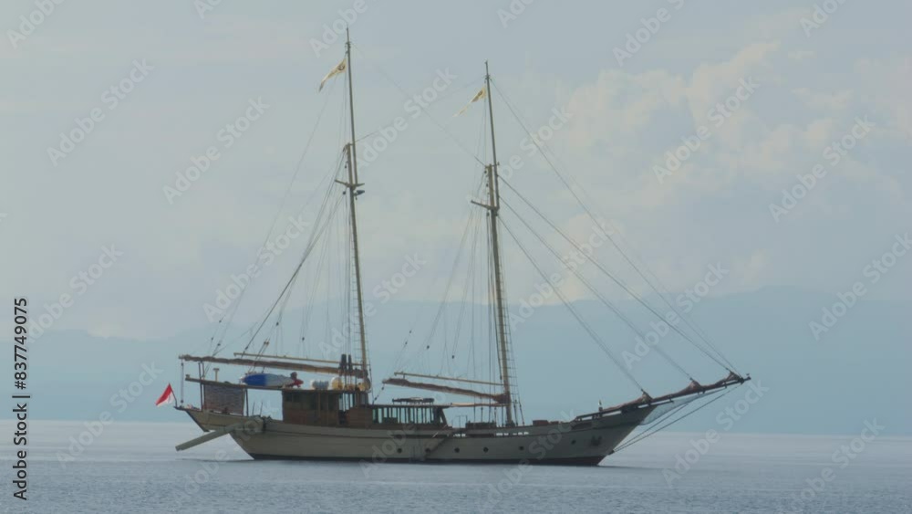 two-masted yacht anchored near Kri Island, Raja Ampat, Indonesia. Static shot. two-masted yacht anchored near Kri Island, Raja Ampat, Indonesia. Static shot.