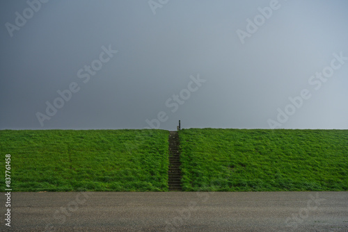 Wallpaper Mural Netherlands, Zeeland, Asphalt road in front of green levee Torontodigital.ca