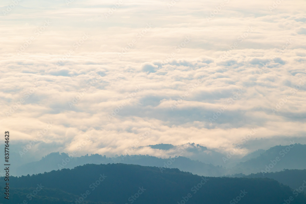 Morning view over white puffy clouds with blue sky on horizon. Morning view over white puffy clouds with blue sky on horizon.