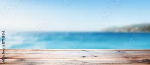 Product placement potential on a blue wooden board with a blurred sparkling sea in the background, perfect for a summer holiday concept with copy space image.
