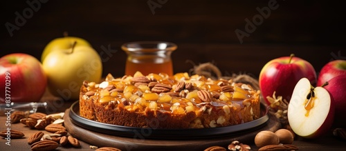 Charlotte dessert with apples and nuts arranged for baking next to a sweet honey drizzle  creating a delightful dessert scene on a rustic wooden table with copy space image.