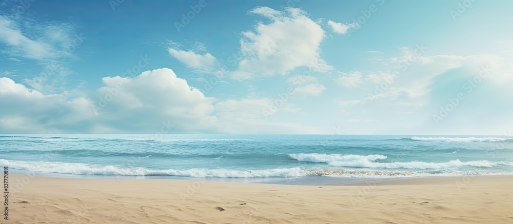 Fototapeta premium Sandy beach backdrop with sea and sky, embodying a summer theme, perfect for a copy space image.
