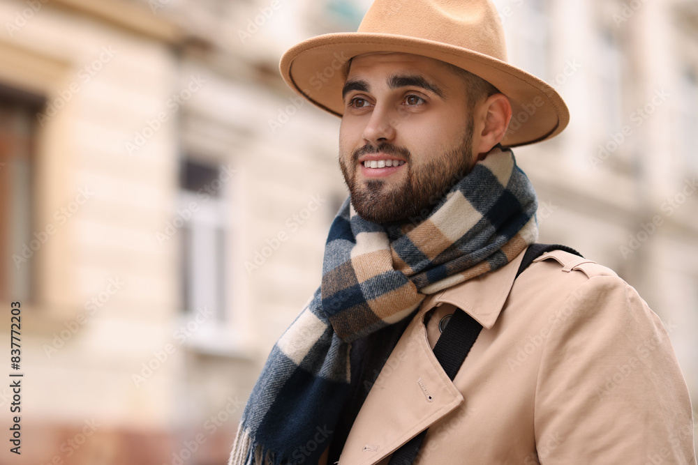 Smiling man in warm scarf outdoors. Space for text Smiling man in warm scarf outdoors. Space for text