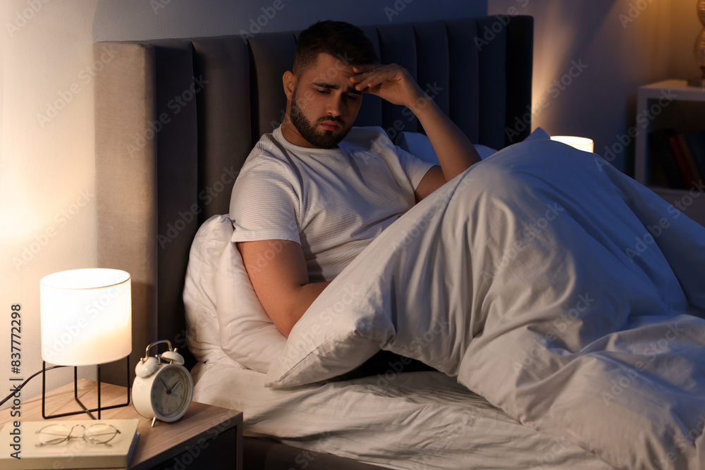 Frustrated man suffering from insomnia in bed Frustrated man suffering from insomnia in bed