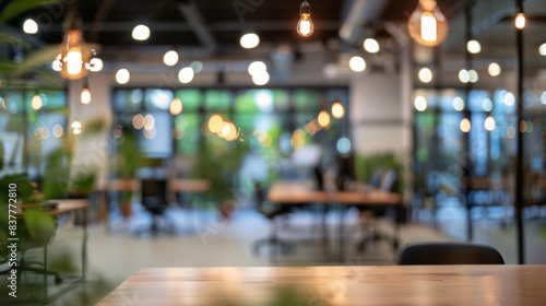 Wallpaper Mural Blurred office background with empty desk. Modern coworking space with empty desk in focus, blurred background of open plan office with natural light and green plants. Torontodigital.ca