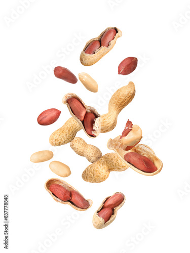 Many peanuts in air on white background