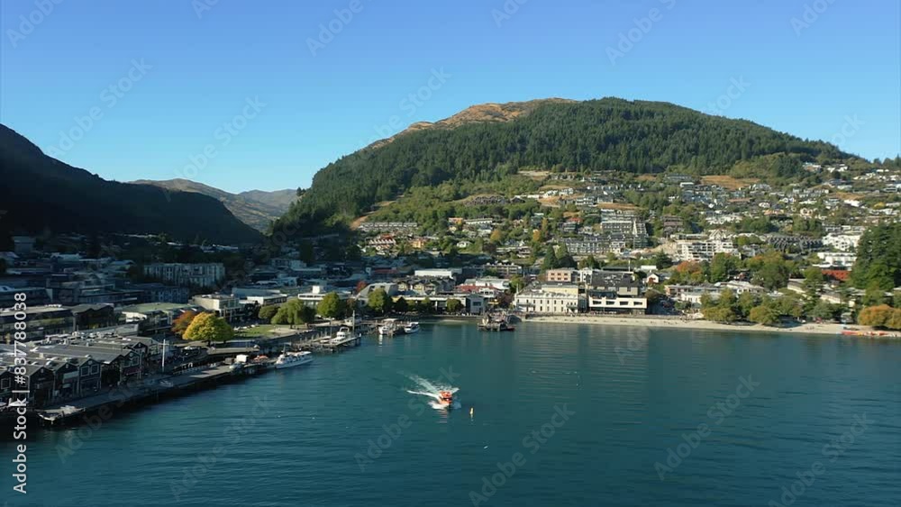 Boat leaving port in Queenstown, New Zealand, aerial view reverse dolly. Boat leaving port in Queenstown, New Zealand, aerial view reverse dolly.