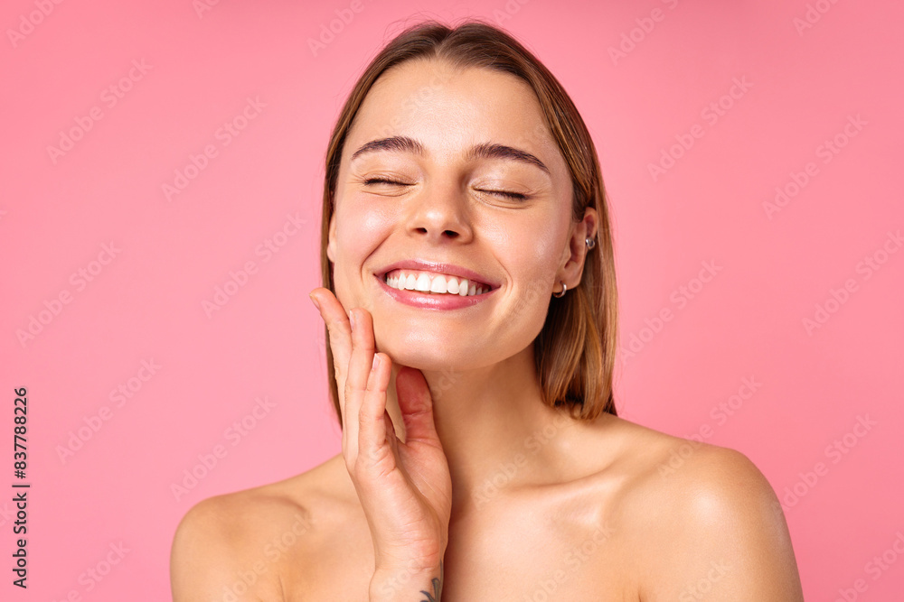 Portrait of a young woman with radiant skin and natural beauty on a pink background Portrait of a young woman with radiant skin and natural beauty on a pink background