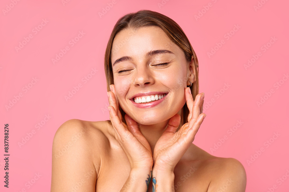 Portrait of a young woman with radiant skin and natural beauty on a pink background Portrait of a young woman with radiant skin and natural beauty on a pink background
