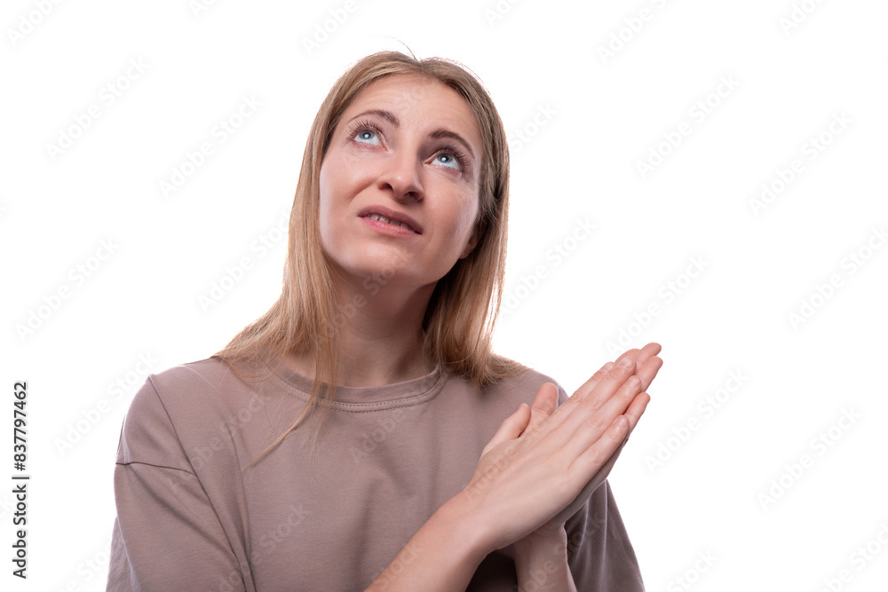 European adult woman with blond hair looking up against white background European adult woman with blond hair looking up against white background