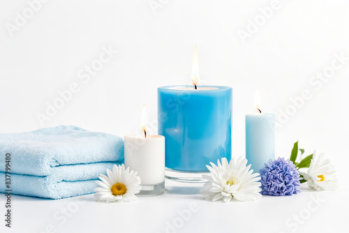 Three blue and white candles on a white background with flowers