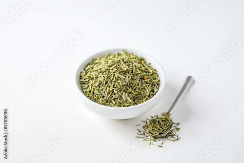 Dried Tarragon in a White Bowl with Spoon