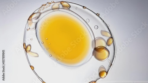 Transparent cosmetic gel fluid with molecule bubbles oil distribution on a white background. Macro Shot of Natural Organic Cosmetics, Medicine. Production Close-up. Slow Motion