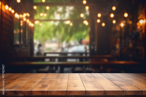 Wooden table against outdoor at street evening bar, featuring blurry defocused background with enchanting lights and copy space, backdrop for product or montage