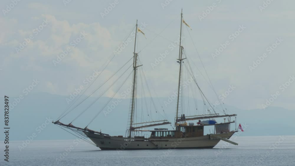 two-masted yacht anchored near Kri Island, Raja Ampat, Indonesia. Static shot. two-masted yacht anchored near Kri Island, Raja Ampat, Indonesia. Static shot.