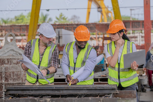 Engineer or foreman worker architecture  safety uniform survey at structure building site blueprint and notebook  check detail and measure of common work is building architecture business concept.