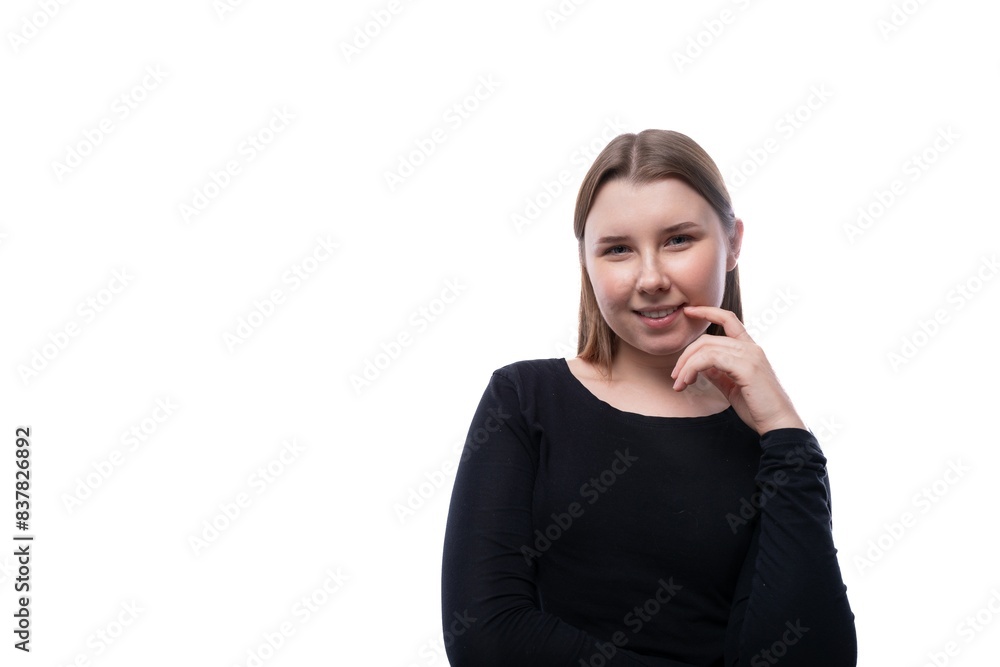 European charming schoolgirl dressed in a black blouse holds a thumbs up European charming schoolgirl dressed in a black blouse holds a thumbs up