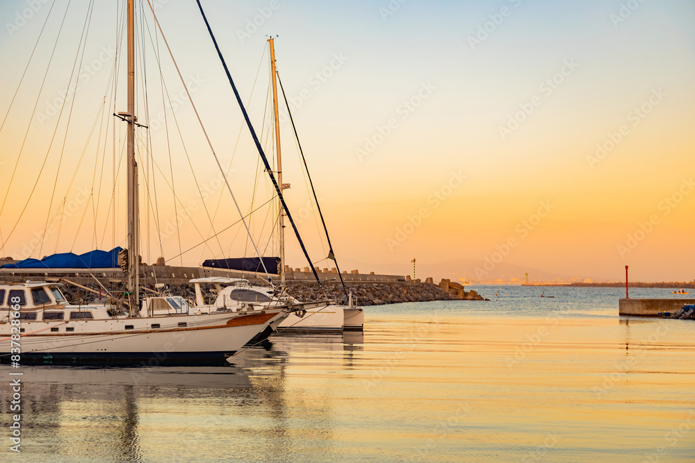 leisure yacht sailboats docked at small harbour in Cape Town at sunset leisure yacht sailboats docked at small harbour in Cape Town at sunset