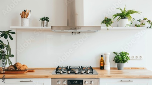 Modern kitchen with induction hob and extractor hood above wooden countertop