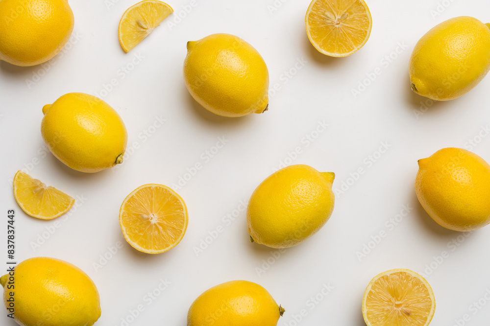 Many fresh ripe lemons as colored background, top view. Elegant background of lemon and lemon slices Top view flat lay Many fresh ripe lemons as colored background, top view. Elegant background of lemon and lemon slices Top view flat lay