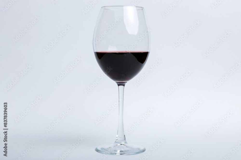 One glasses of red wine at wine tasting. Concept of red wine on colored background. Top view, flat lay design One glasses of red wine at wine tasting. Concept of red wine on colored background. Top view, flat lay design