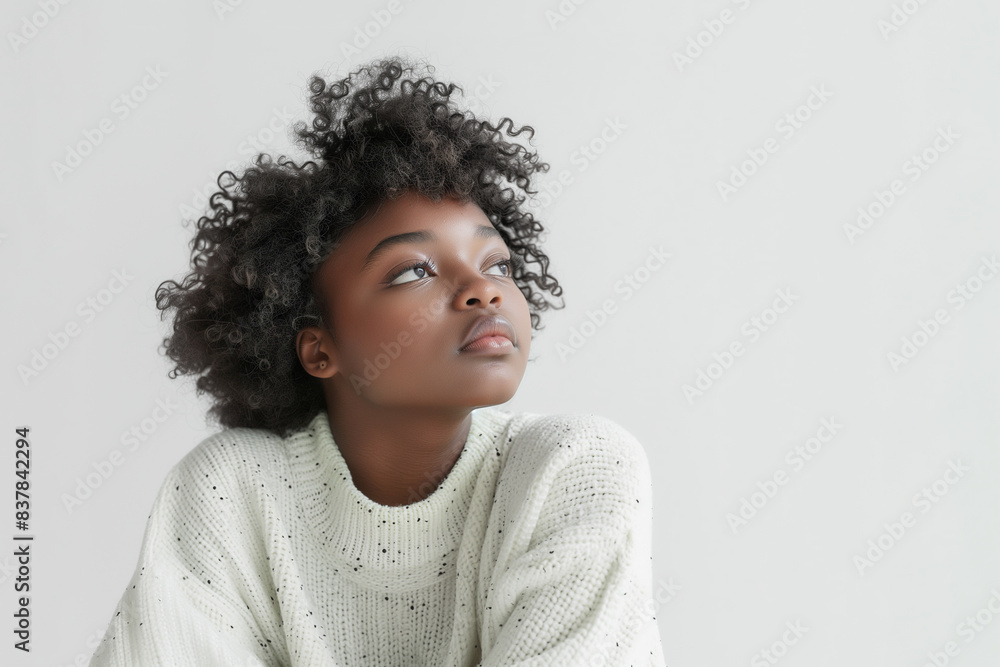 A young African American girl with curly hair, wearing a light-colored sweater. Her thoughtful expression and stylish attire convey a sense of modern elegance. A young African American girl with curly hair, wearing a light-colored sweater. Her thoughtful expression and stylish attire convey a sense of modern elegance.