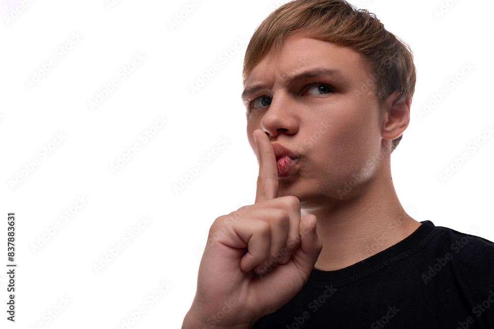 Portrait of a charming teenage guy with light brown hair keeping a secret Portrait of a charming teenage guy with light brown hair keeping a secret