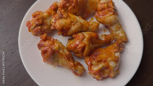 roasted spicy chicken wing in a white plate 