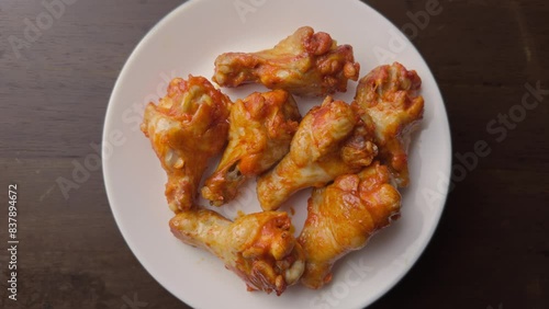 roasted spicy chicken wing in a white plate 