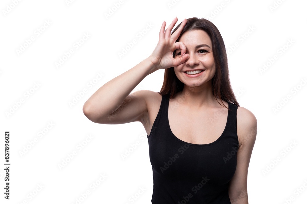 Casual pretty young brunette woman wearing a black t-shirt on a white background Casual pretty young brunette woman wearing a black t-shirt on a white background