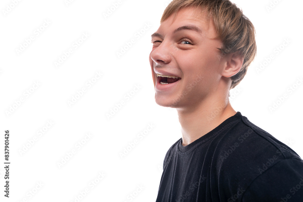 Charismatic teenage guy with blond hair makes a grimace Charismatic teenage guy with blond hair makes a grimace