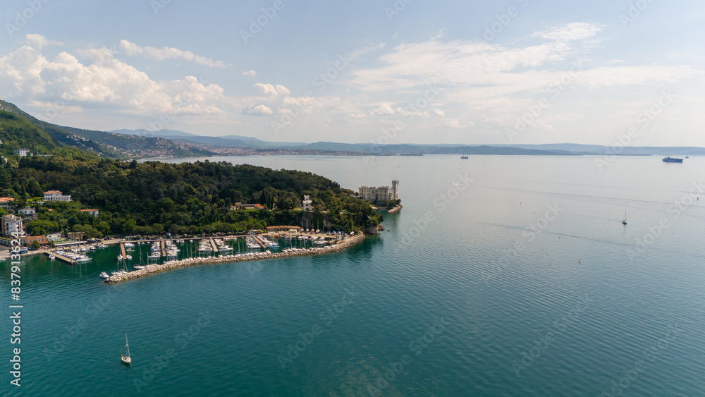 Aerial view of a coastal town nestled between mountains Aerial view of a coastal town nestled between mountains