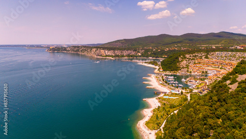 Aerial view of a coastal town nestled between mountains