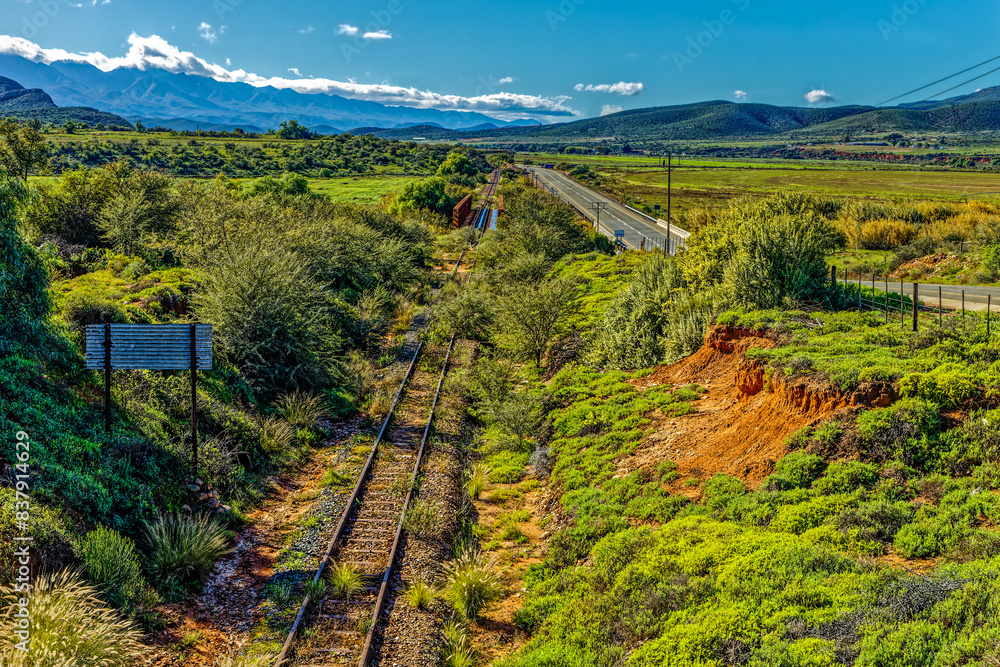 Landscape of Route 62 and old abandoned railway line with Swartberg mountain range in background landscape near Oudtshoorn, Little Karoo, Western Cape