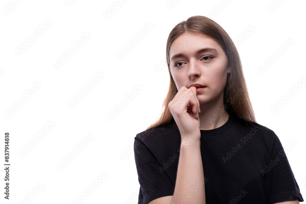 Charming fair-haired teenage girl in a black T-shirt on a white background Charming fair-haired teenage girl in a black T-shirt on a white background