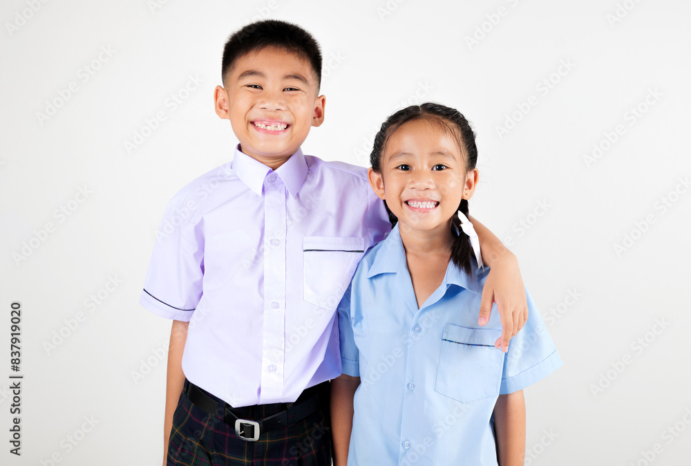 Portrait two smile Asian little girl kindergarten and boy primary posing studio isolated white background, happy cute woman and man kid brother sister wear school uniform plaid, back to school concept Portrait two smile Asian little girl kindergarten and boy primary posing studio isolated white background, happy cute woman and man kid brother sister wear school uniform plaid, back to school concept