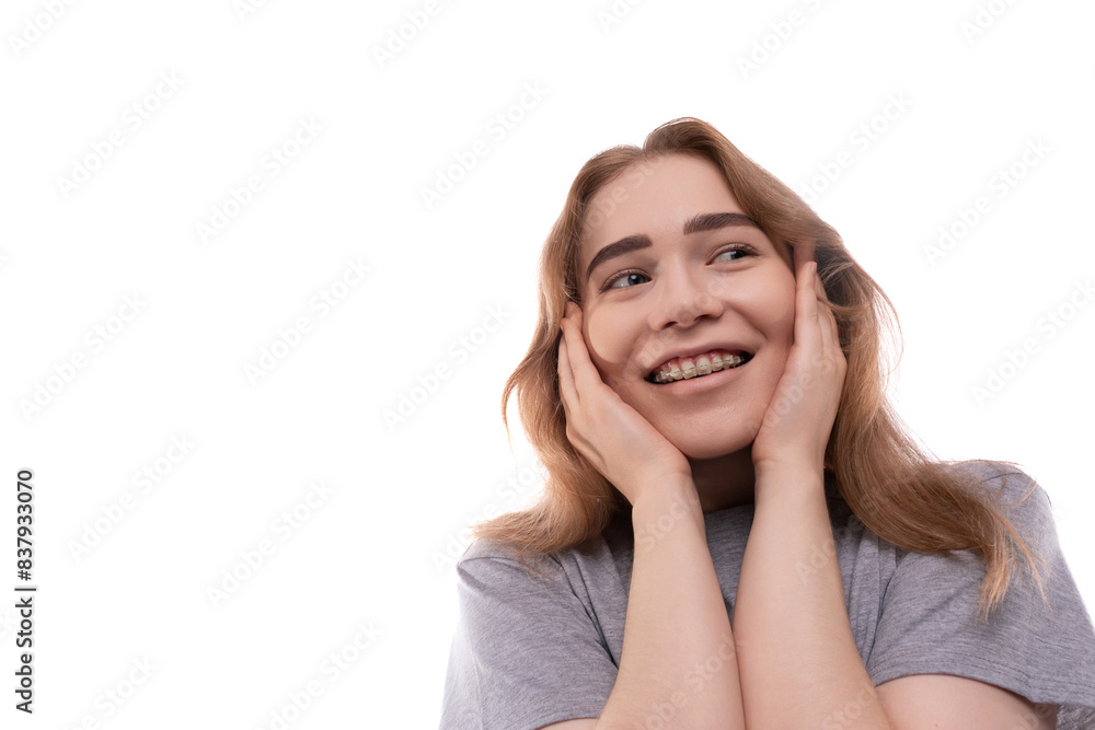 Kind modest bright blond teenager girl with braces in a gray T-shirt Kind modest bright blond teenager girl with braces in a gray T-shirt