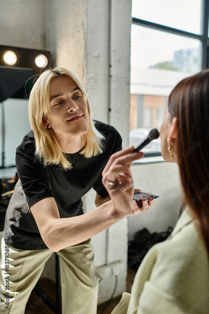 Handsome makeup artist transforms a womans look. Handsome makeup artist transforms a womans look.